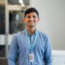Young man looking at camera smiling, man in business, education, smiling, stability